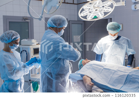 Surgery preparations. Surgical team preparing their patient for surgery 116120335