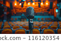 A Vintage Microphone Awaits On Stage In A Dark Auditorium 116120354