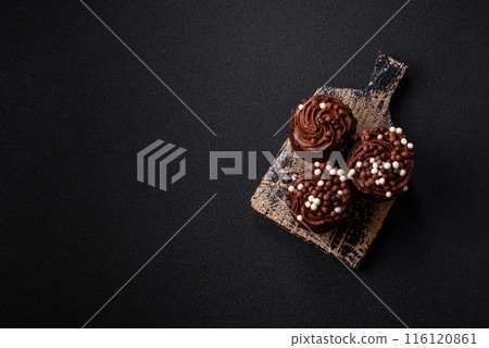 Delicious fresh muffins with filling and chocolate coating 116120861