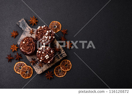 Delicious fresh muffins with filling and chocolate coating Delicious fresh muffins with filling and chocolate coating 116120872