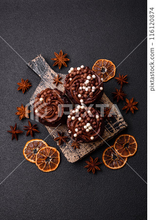 Delicious fresh muffins with filling and chocolate coating 116120874