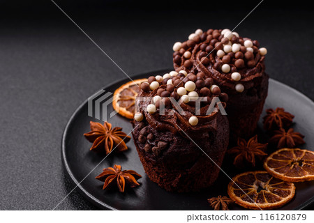 Delicious fresh muffins with filling and chocolate coating Delicious fresh muffins with filling and chocolate coating 116120879