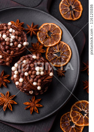 Delicious fresh muffins with filling and chocolate coating Delicious fresh muffins with filling and chocolate coating 116120886