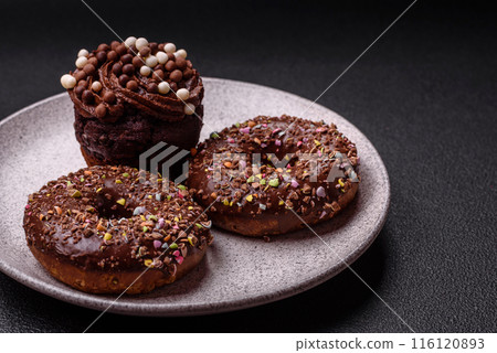 Delicious fresh donuts with filling and chocolate coating Delicious fresh donuts with filling and chocolate coating 116120893