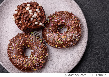 Delicious fresh donuts with filling and chocolate coating Delicious fresh donuts with filling and chocolate coating 116120894