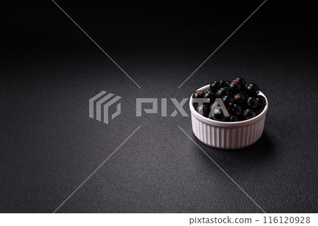 Ripe blackcurrant berries in droplets of water in a ceramic bowl Ripe blackcurrant berries in droplets of water in a ceramic bowl 116120928