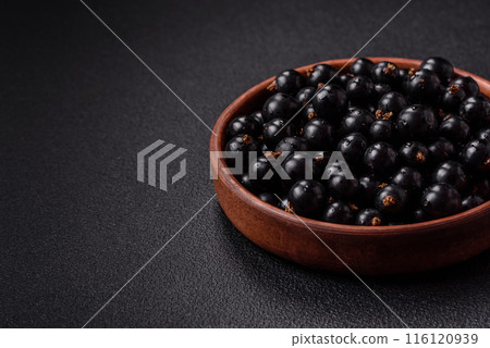 Ripe blackcurrant berries in droplets of water in a ceramic bowl Ripe blackcurrant berries in droplets of water in a ceramic bowl 116120939
