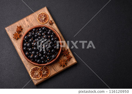 Ripe blackcurrant berries in droplets of water in a ceramic bowl Ripe blackcurrant berries in droplets of water in a ceramic bowl 116120950