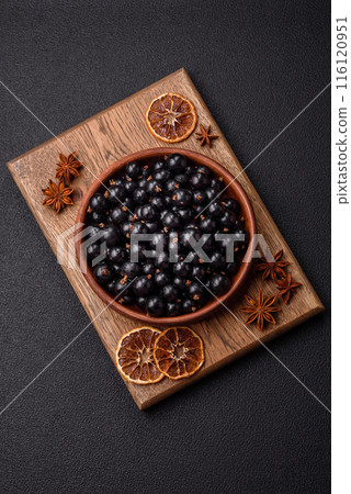 Ripe blackcurrant berries in droplets of water in a ceramic bowl Ripe blackcurrant berries in droplets of water in a ceramic bowl 116120951