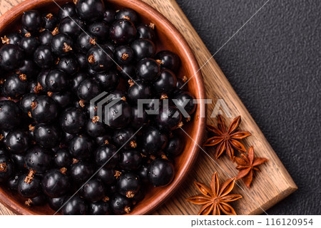 Ripe blackcurrant berries in droplets of water in a ceramic bowl Ripe blackcurrant berries in droplets of water in a ceramic bowl 116120954