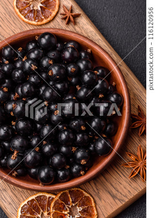 Ripe blackcurrant berries in droplets of water in a ceramic bowl Ripe blackcurrant berries in droplets of water in a ceramic bowl 116120956
