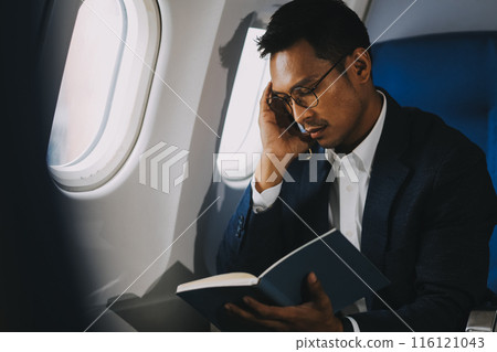 Business Man Having Headache Pain or Frustration Problem in Interior of an Airplane, Corporate Airline Travel Concept Business Man Having Headache Pain or Frustration Problem in Interior of an Airplane, Corporate Airline Travel Concept 116121043