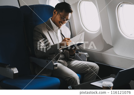 Airplane, travel and portrait of businessman working on laptop computer and smartphone while sitting in airplane. 116121076