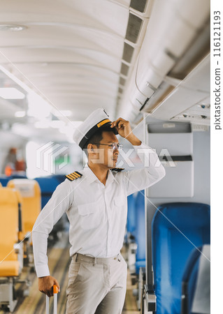 Portrait of a trained airplane captain in uniform preparing to fly in a simulator cockpit. Portrait of a trained airplane captain in uniform preparing to fly in a simulator cockpit. 116121193