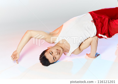 Korean breakdancer performing Air Chair element of downrock breakdance. 116121201