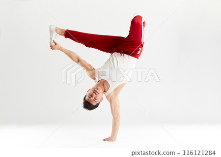 Korean dancer executes basic freezes of downrock brea dance isolated on white Korean dancer executes basic freezes of downrock brea dance isolated on white 116121284