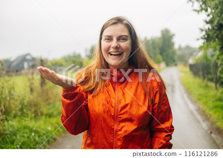 Happy woman hand catching rain drops, enjoying spring rain falling on park background. Happy woman hand catching rain drops, enjoying spring rain falling on park background. 116121286