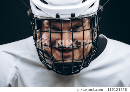 Portrait of sportsman in hockey uniform over black background 116121858