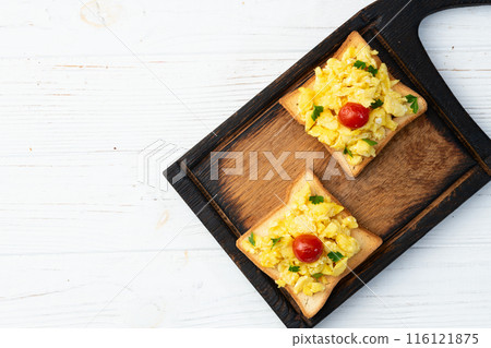 Healthy vegetarian breakfast . Scrambled eggs toast with cherry tomatoes and parsley Healthy vegetarian breakfast . Scrambled eggs toast with cherry tomatoes and parsley 116121875