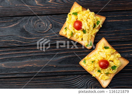 Healthy vegetarian breakfast . Scrambled eggs toast with cherry tomatoes and parsley Healthy vegetarian breakfast . Scrambled eggs toast with cherry tomatoes and parsley 116121879