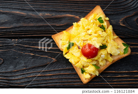 Healthy vegetarian breakfast . Scrambled eggs toast with cherry tomatoes and parsley Healthy vegetarian breakfast . Scrambled eggs toast with cherry tomatoes and parsley 116121884
