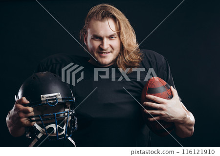 Determined American football player in action isolated on black background 116121910