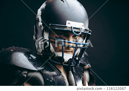 American football player with ball wearing helmet and protective shields American football player with ball wearing helmet and protective shields 116122087