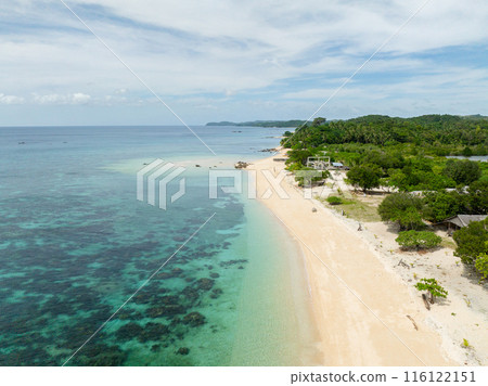 Transparent turquoise sea water with corals. Waves on white sand beach in Santa Fe, Tablas, Romblon. Philippines. Transparent turquoise sea water with corals. Waves on white sand beach in Santa Fe, Tablas, Romblon. Philippines. 116122151