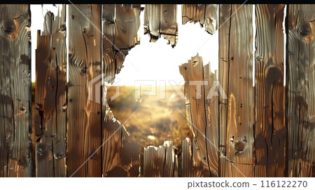 Rustic Wooden Fence with Hole Revealing Landscape 116122270