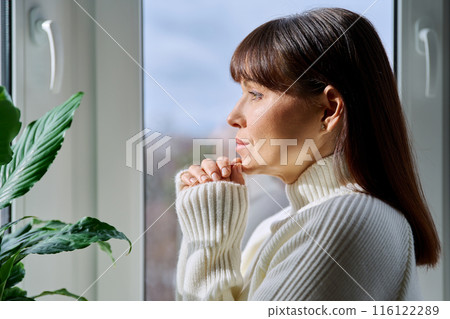 Profile view of beautiful happy mature woman looking out the window Profile view of beautiful happy mature woman looking out the window 116122289