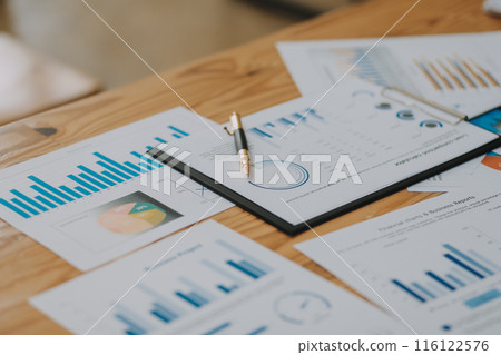 Happy young asian businesswoman sitting on her workplace in the office. Young woman working at laptop in the office. 116122576