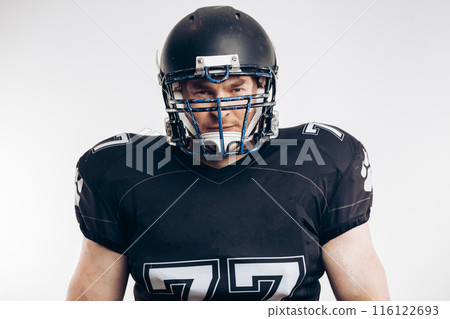 American football player with helmet and armour against white background American football player with helmet and armour against white background 116122693