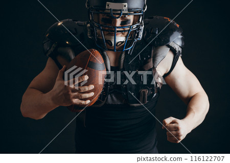 American football player with ball wearing helmet and protective shields American football player with ball wearing helmet and protective shields 116122707