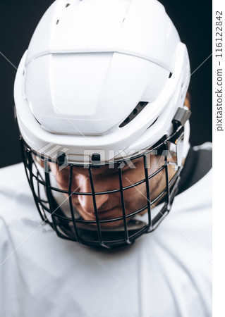 Portrait of sportsman in hockey uniform over black background Portrait of sportsman in hockey uniform over black background 116122842