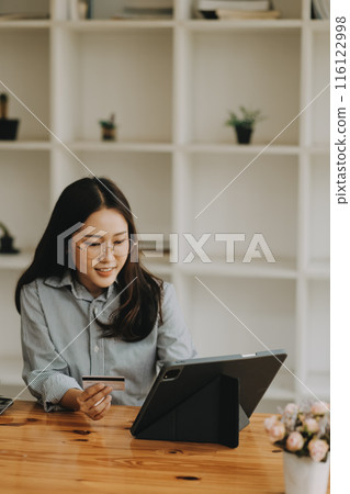 Happy asian woman using smartphone shopping online with credit card. Lifestyle. Easy pay using smart phone or digital device. Happy asian woman using smartphone shopping online with credit card. Lifestyle. Easy pay using smart phone or digital device. 116122998