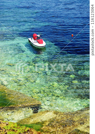 The turquoise sea water is near beach and water jet bike, Bugibba, Malta 116123064