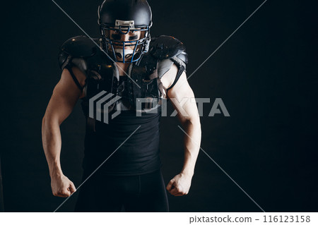 American football player with ball wearing helmet and protective shields American football player with ball wearing helmet and protective shields 116123158