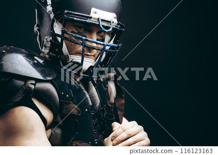 American football player with ball wearing helmet and protective shields American football player with ball wearing helmet and protective shields 116123163