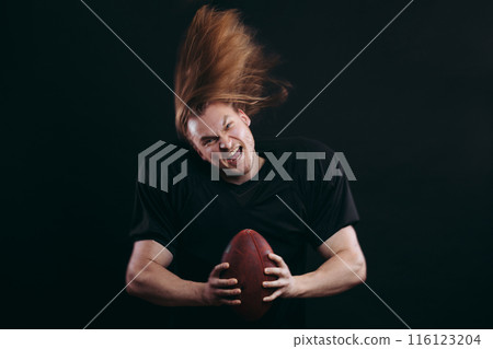 Quarterback throwing a football in a professional football game 116123204