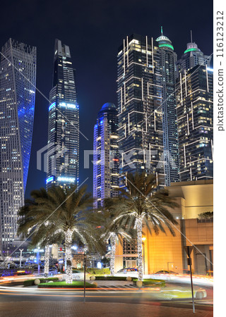 The night illumination of Dubai Marina and Cayan Tower, Dubai, UAE The night illumination of Dubai Marina and Cayan Tower, Dubai, UAE 116123212