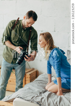 sweet lovely girl controlling the work of a photographer 116123259