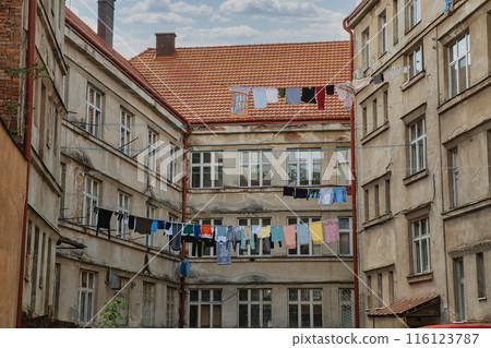Courtyard of an old house with laundry drying on a line 116123787