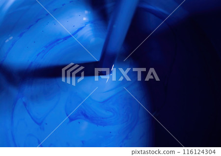 Stirring blue paint Stirring blue paint 116124304