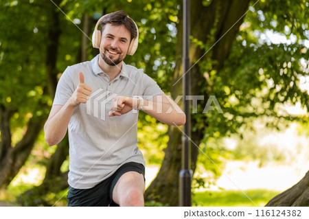 Runner jogger man starting smart watch timer and running checking heart rate monitor before jogging Runner jogger man starting smart watch timer and running checking heart rate monitor before jogging 116124382