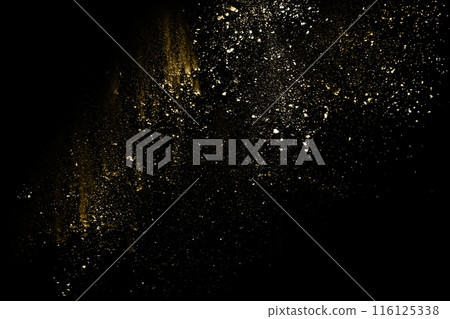 Golden powder explosion on black background. Freeze motion. Golden powder explosion on black background. Freeze motion. 116125338
