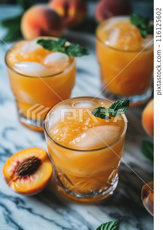 Peach Moonshine. Peach iced tea with ice cubes in a glass on a wooden table. 116125602