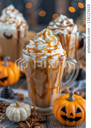 Pumpkin spice latte with whipped cream and caramel drizzle on wooden table. Pumpkin spice latte with whipped cream and caramel drizzle on wooden table. 116125628