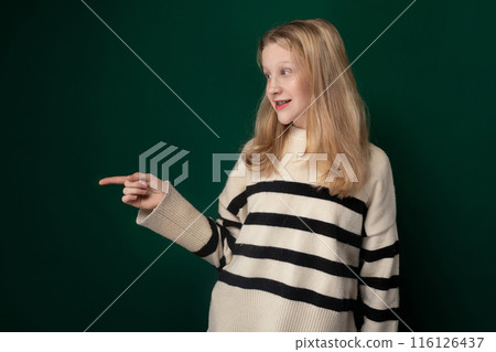 Woman Standing in Front of Green Wall Woman Standing in Front of Green Wall 116126437