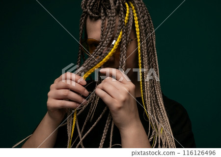 Woman With Dreadlocks Holding a Pair of Glasses 116126496