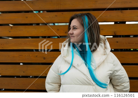 Woman With Blue Hair Standing in Front of Wooden Wall 116126501